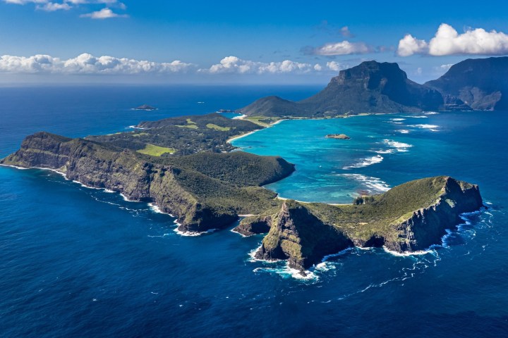 an island in the middle of a body of water with Lord Howe Island in the background