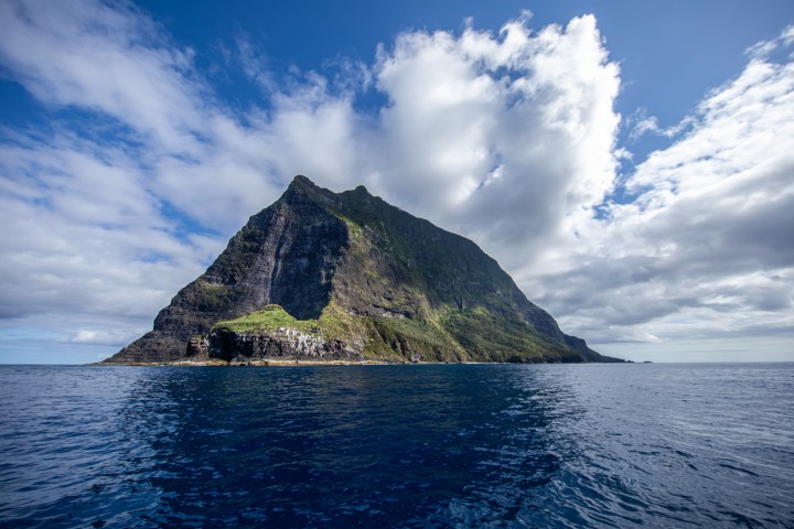 a body of water with Pitons in the background